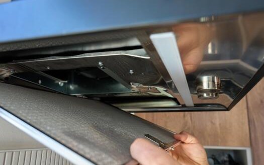 Cooker hood filter being removed