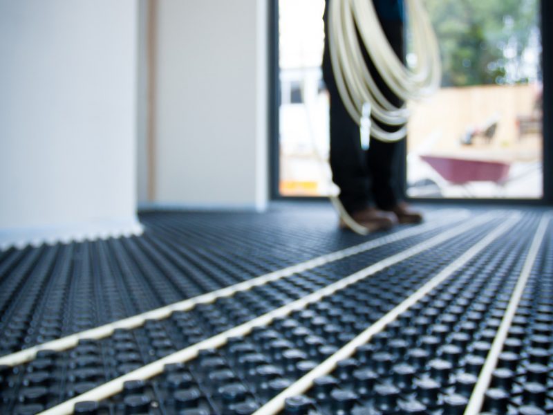 Underfloor heating pipes laid in a clip-rail panel system