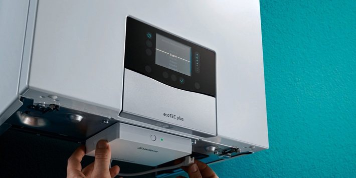 Smart connectivity module being fitted underneath a Vaillant boiler