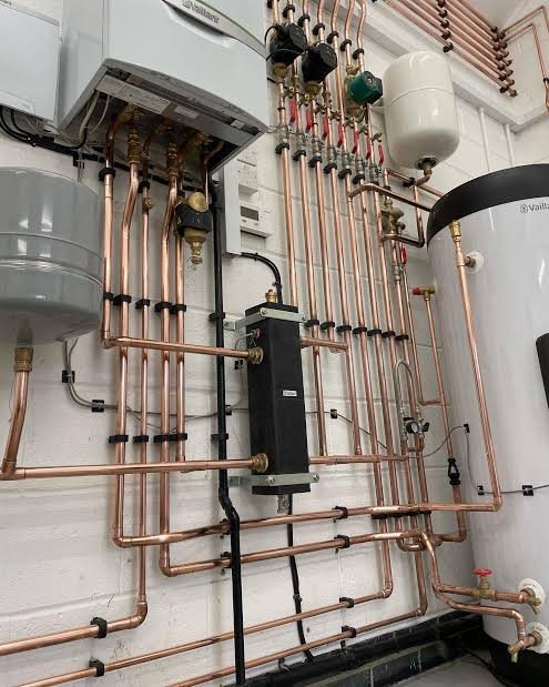 Boiler, zone valves and expansion vessel with neatly clipped copper pipework and an unvented cylinder