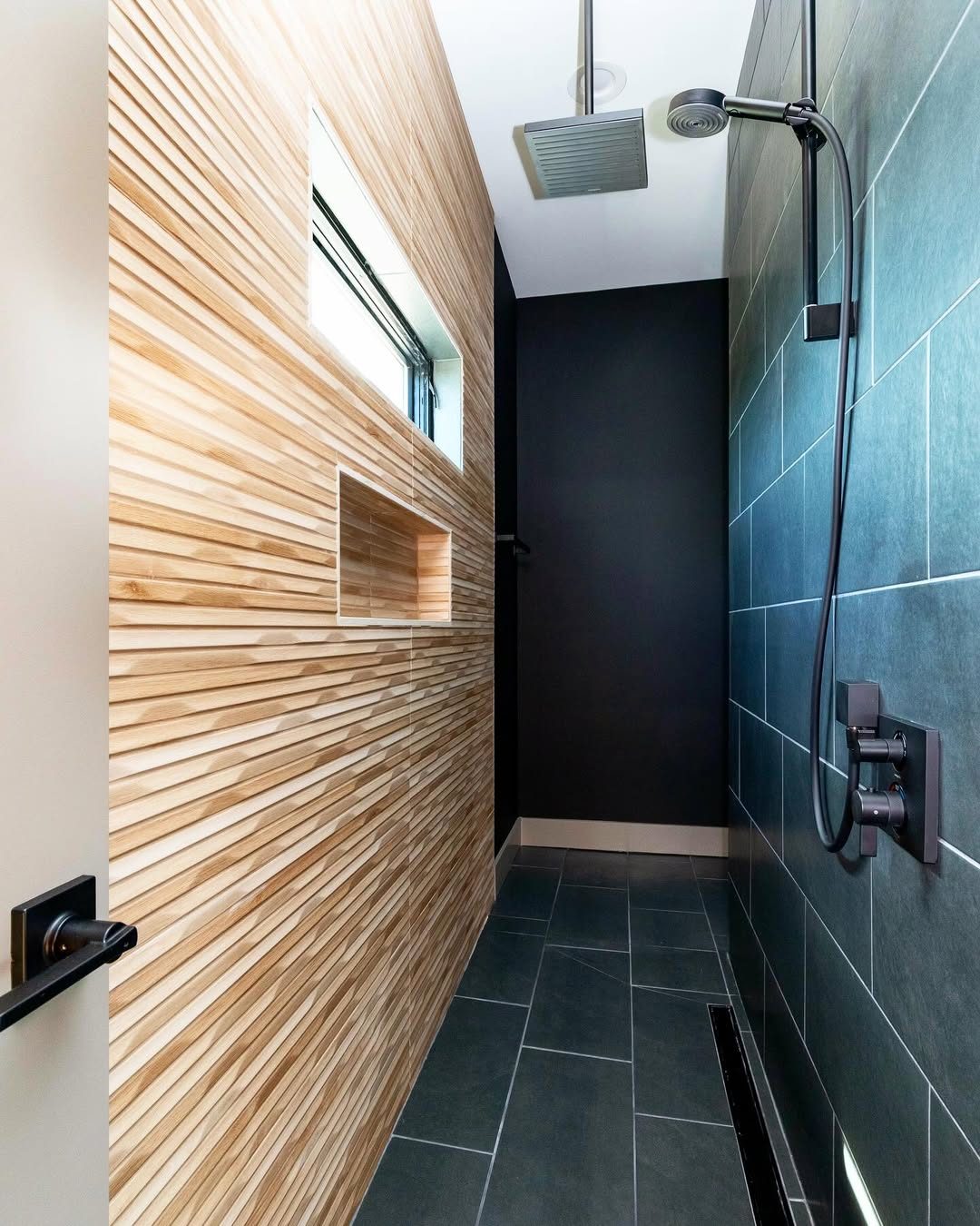Walk-in shower with a rainfall head and a linear floor drain