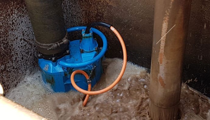 Blue submersible pump running in a foaming sump