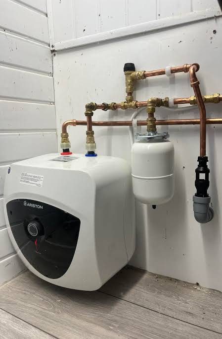 Ariston under-sink water heater with its expansion vessel and safety valves