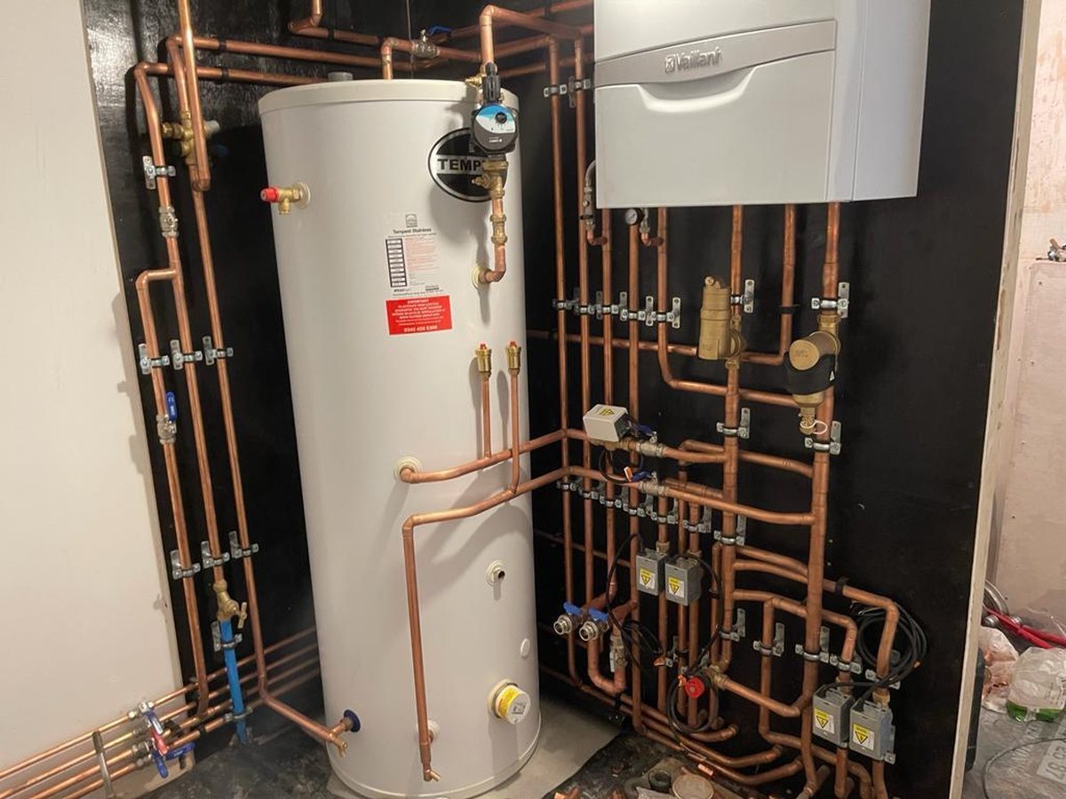 Vaillant system boiler feeding a Tempest unvented cylinder, with separate zone valves and fully labelled isolation throughout.