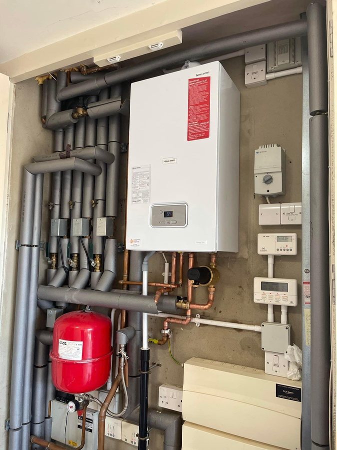 Glow-worm Energy boiler replacement in an existing airing cupboard, reusing the original insulated pipework and controls.